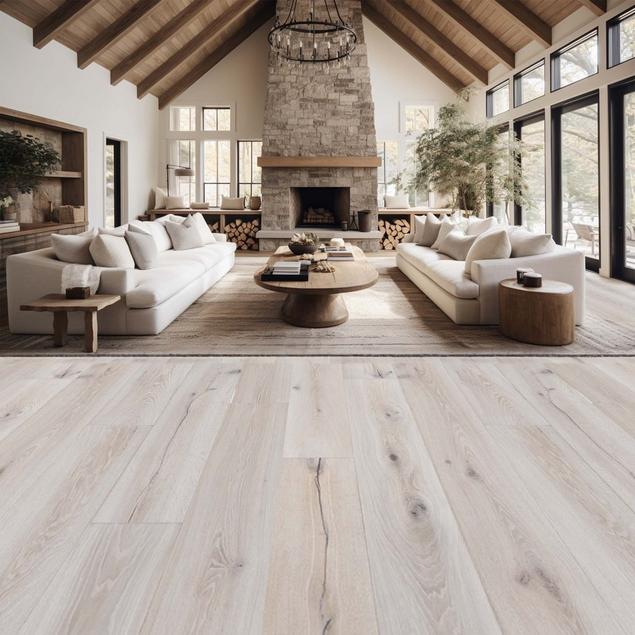 Living room with white walls, medium brown wood beam ceiling, and light gray hardwood flooring.
